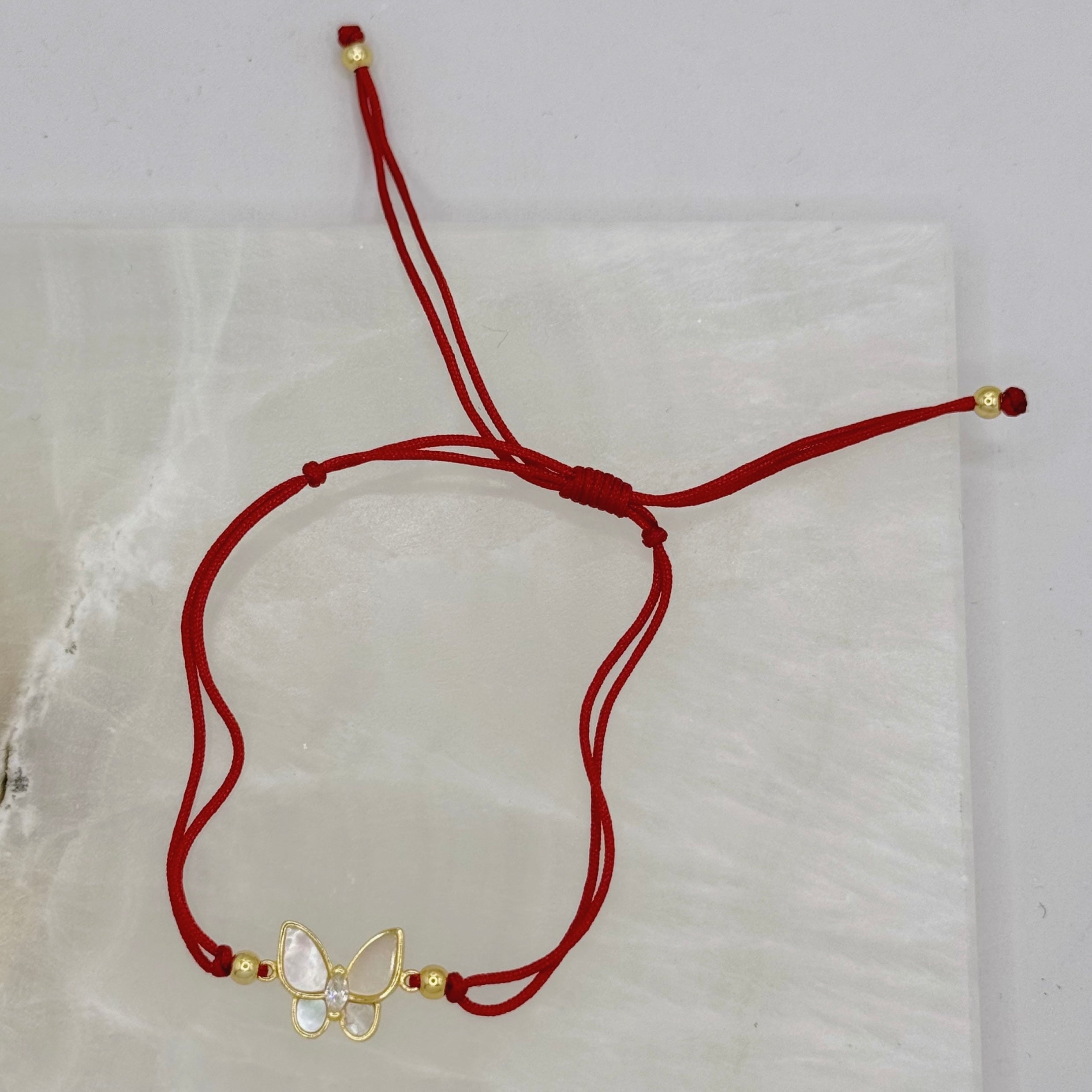 GOLD BUTTERFLY MOTHER OF PEARL RED STRING bracelet