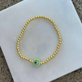 GOLD KIDS GREEN EYE BEADED bracelet