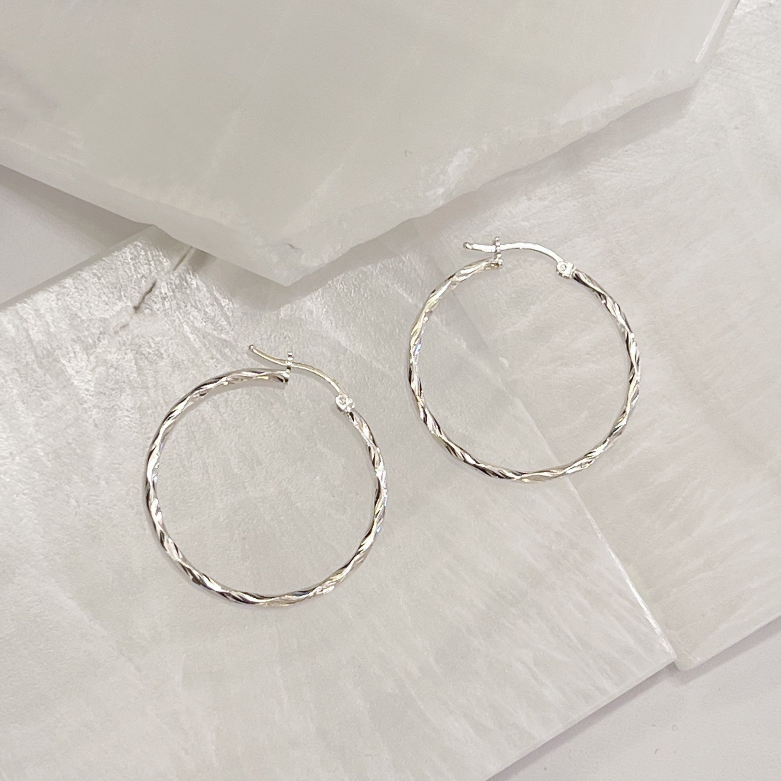 TWISTED SILVER HOOP earring